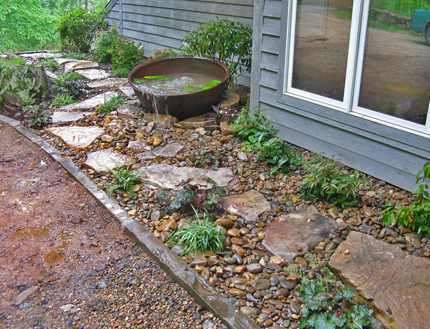 A garden with rocks and a water feature.