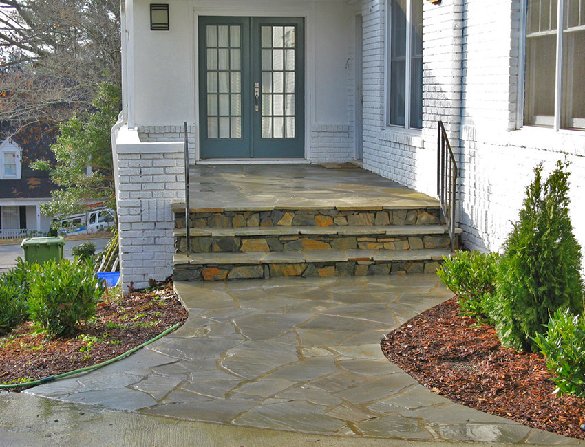 A stone walkway leading to a front door.