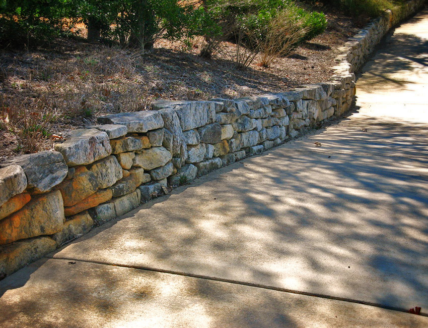 A Stone Wall by the Side of a Pathway
